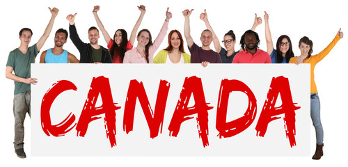 group of diverse people standing behind canada sign